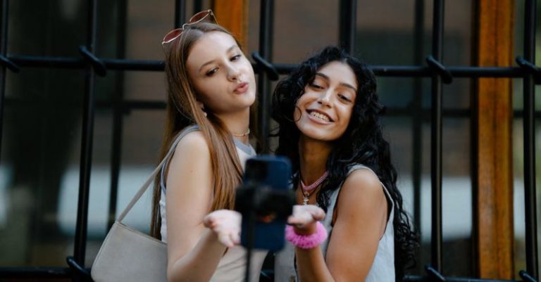 Nano Influencers - Young Fashionable Girls Taking a Picture with a Smartphone on a Tripod