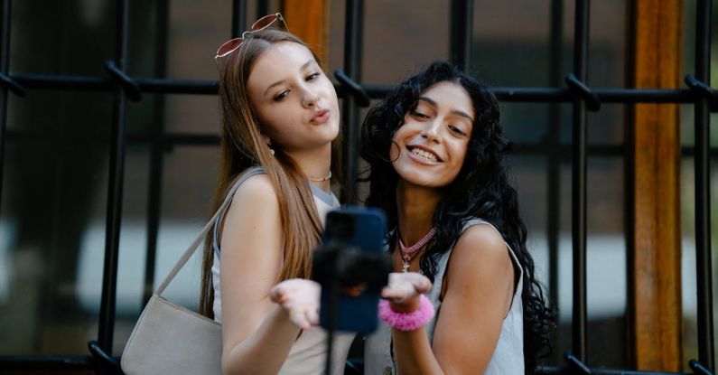 Nano Influencers - Young Fashionable Girls Taking a Picture with a Smartphone on a Tripod