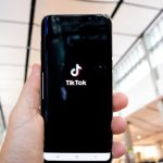 TikTok Logo - Photograph of a Person's Hand Holding a Mobile Phone