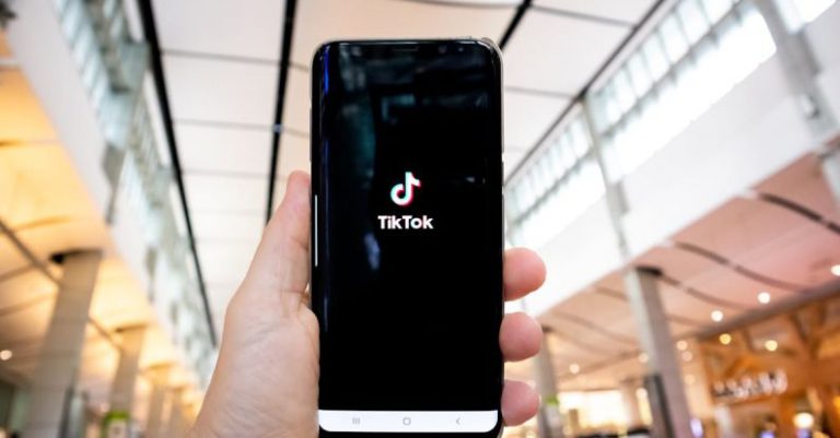 TikTok Logo - Photograph of a Person's Hand Holding a Mobile Phone