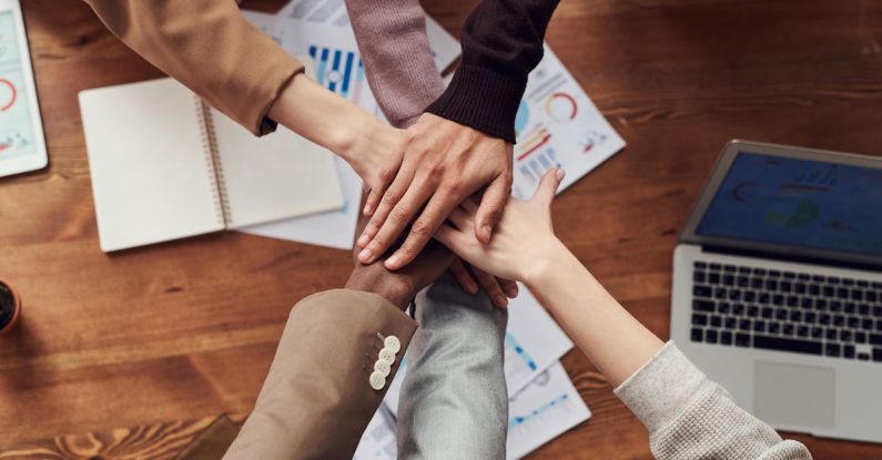 Effective Partnership - Photo Of People Near Wooden Table