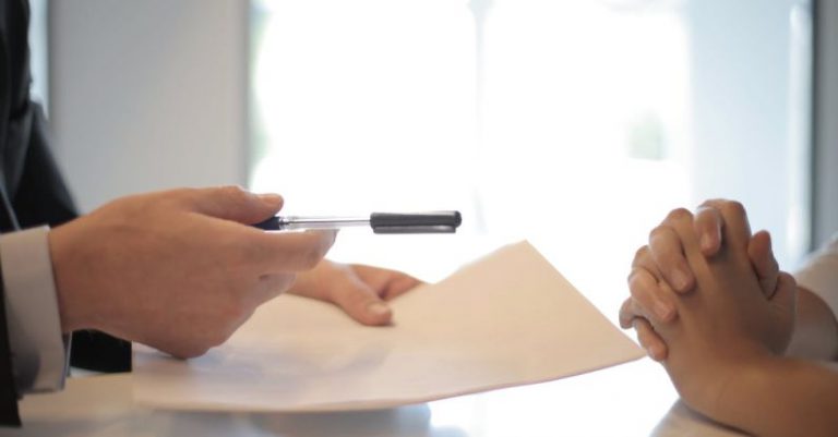 Privacy Policy - Crop businessman giving contract to woman to sign