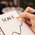 Scaling Arrows - Person Drawing on a Notebook