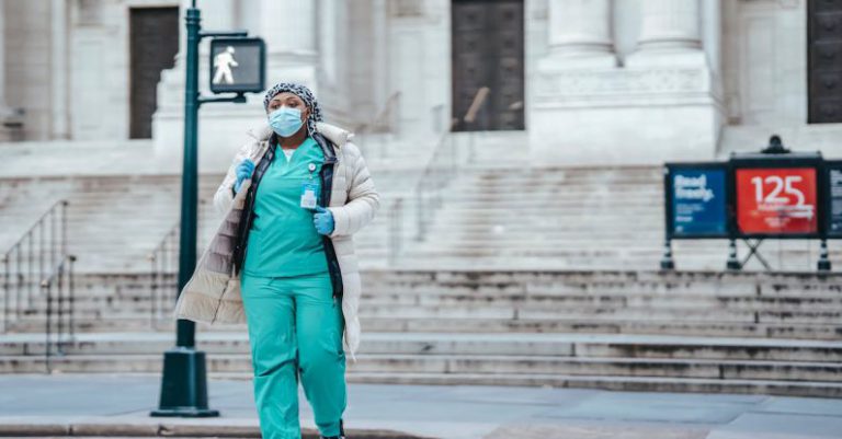 Healthcare Cross - Black physician in uniform crossing city road