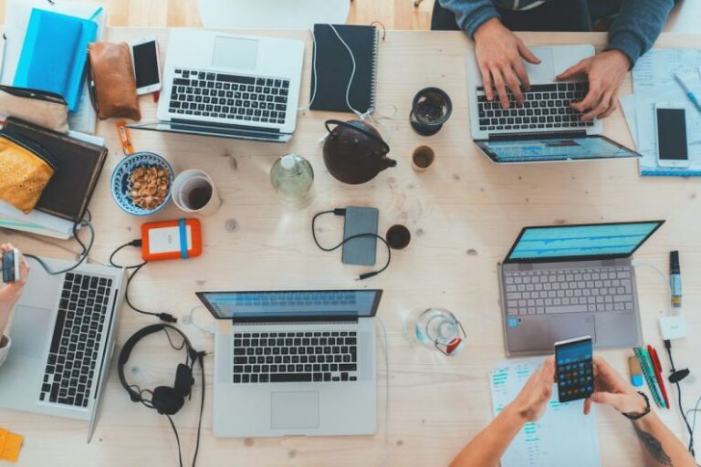 Digital Marketing - people sitting down near table with assorted laptop computers