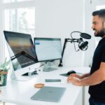 Influencer - man in black t-shirt sitting at the table