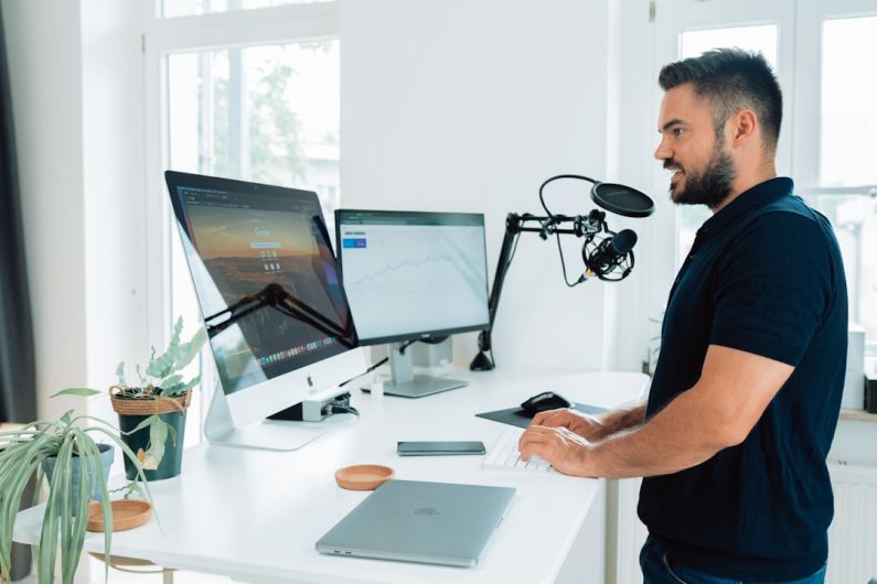 Influencer - man in black t-shirt sitting at the table