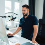 Influencer - man in blue crew neck t-shirt using macbook