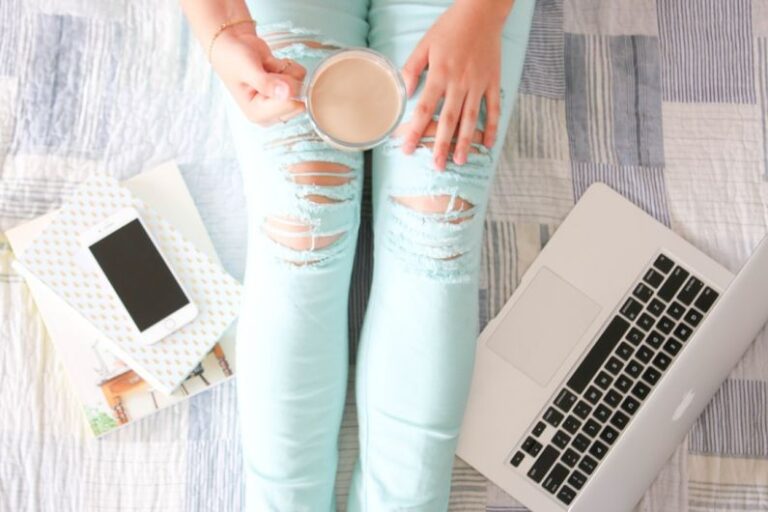 Influencers - person in blue denim jeans holding white ceramic mug