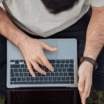 Influencer - person in white shirt using macbook pro