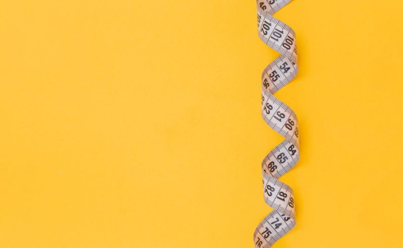 Measuring - black and white snake on yellow background