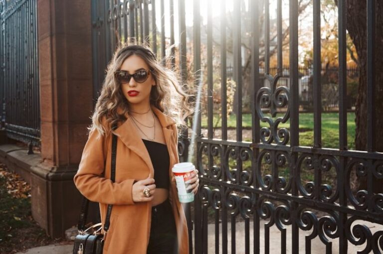 Influencers - woman in brown coat holding white cup
