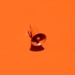 Brand - orange megaphone on orange wall