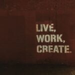Marketing - red brick wall with live, work, create. quote