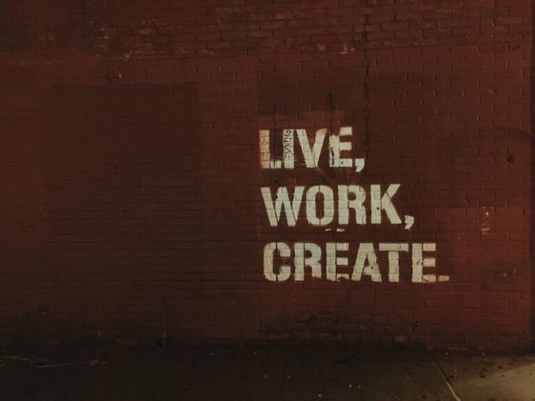 Marketing - red brick wall with live, work, create. quote