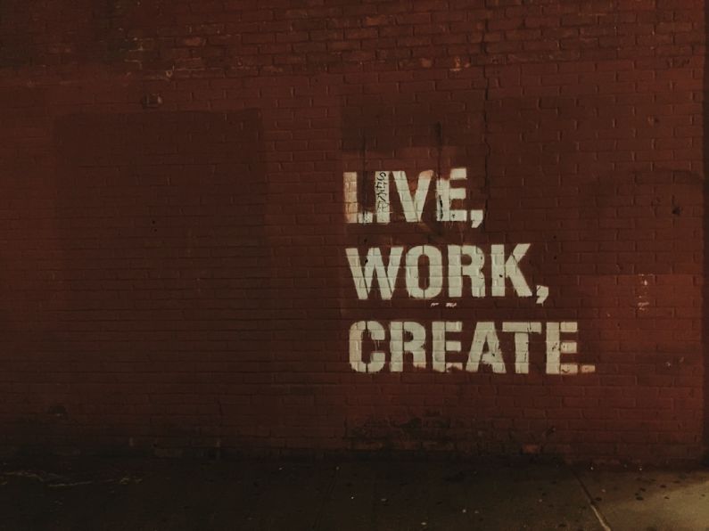 Marketing - red brick wall with live, work, create. quote
