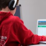 Education Digital - boy in red hoodie wearing black headphones