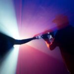 Content - man in black jacket holding camera